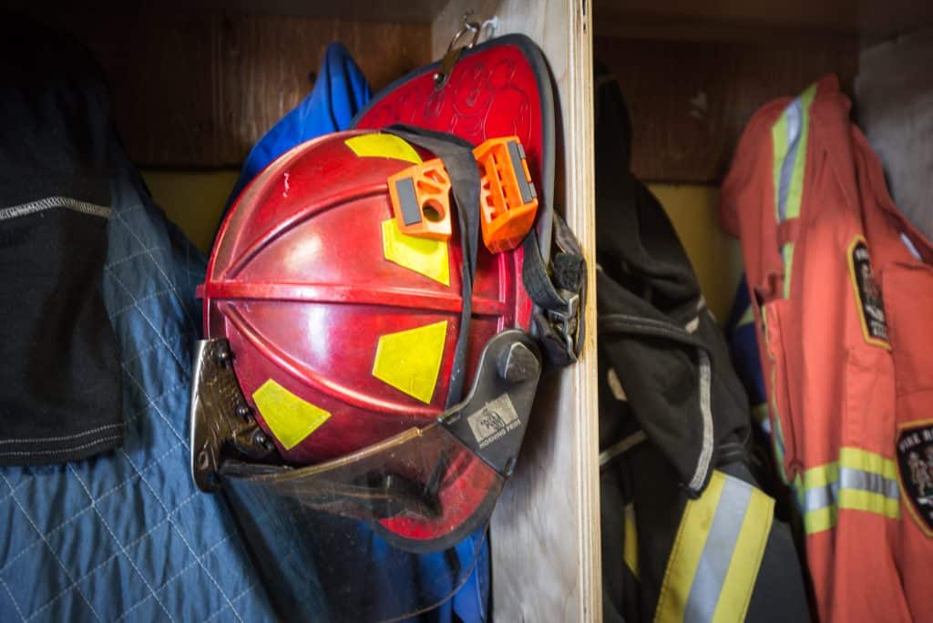 Firefighter helmet hanging in a locker room.