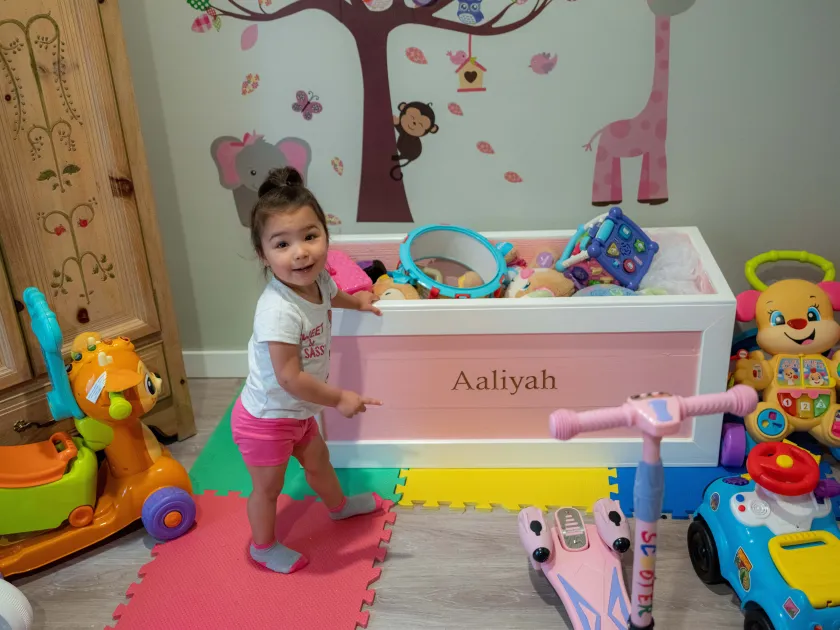 Aaliyah points to her toy box crafted by Doug Eckerty, the executive director of JobSource, which runs Anderson Scholar House.