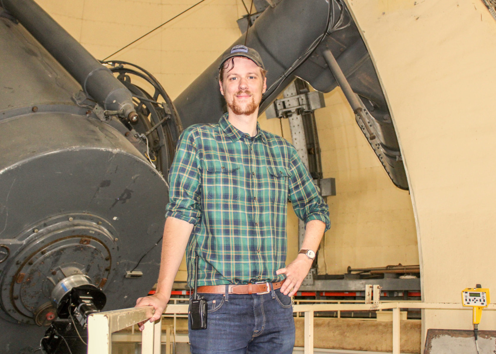 Dark skies specialist Stephen Hummel stands in front of a telescope.