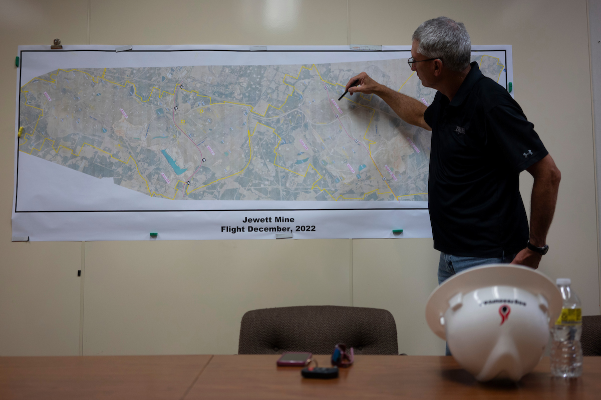 Joe Harris, planning specialist and former reclamation supervisor, point to a map on a wall, showing the environmental reclamation process at the NRG Jewett Mine. 