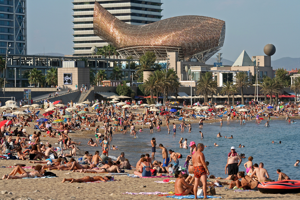Frank Gehry's golden fish sculpture Peix d'Or, built for the 1992 Olympics, is visible from the busy Barceloneta Beach.