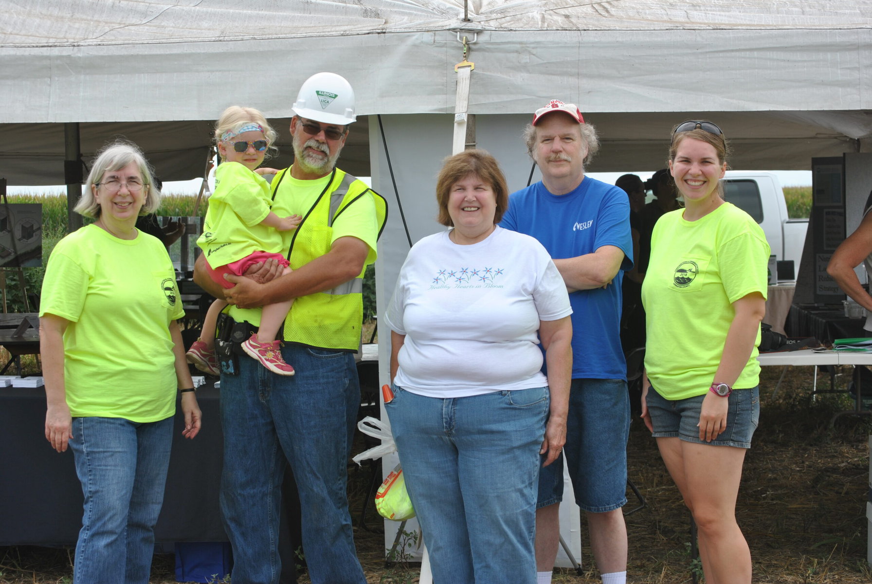 Members of the Fulton family pose together. Several are wearing neon green.