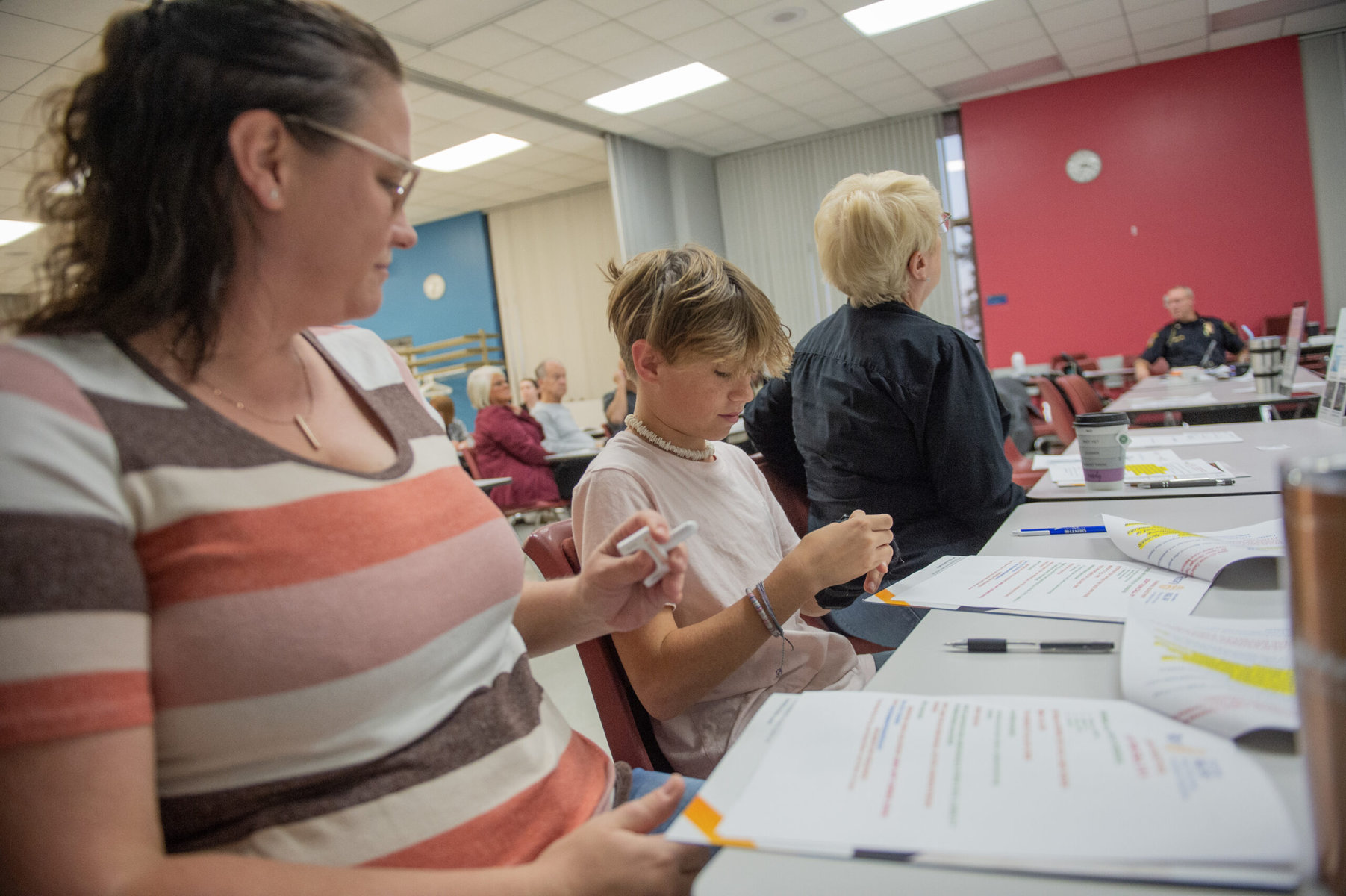 Samantha Appleton (left) and her son attend a training session to learn how to use naloxone to prevent overdose deaths through Project Smart.