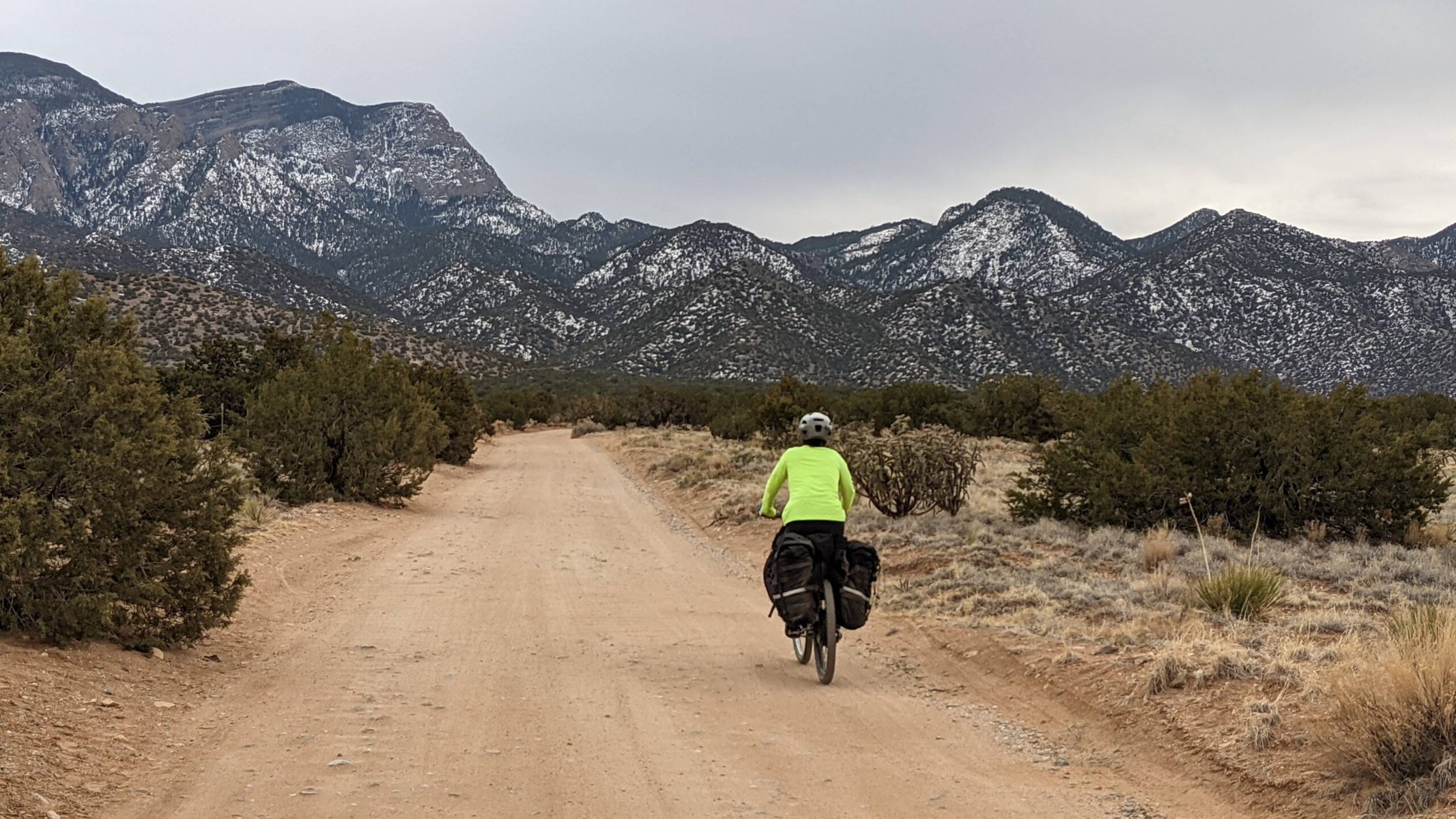 A cyclist on a dirt road in the Sandia Mountains.