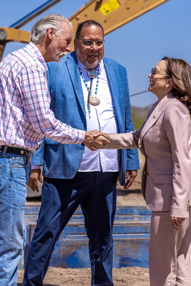 Vice President Kamala Harris shakes hands with David DeJong while Gila River Indian Community Governor Stephen Roe Lewis looks on. 