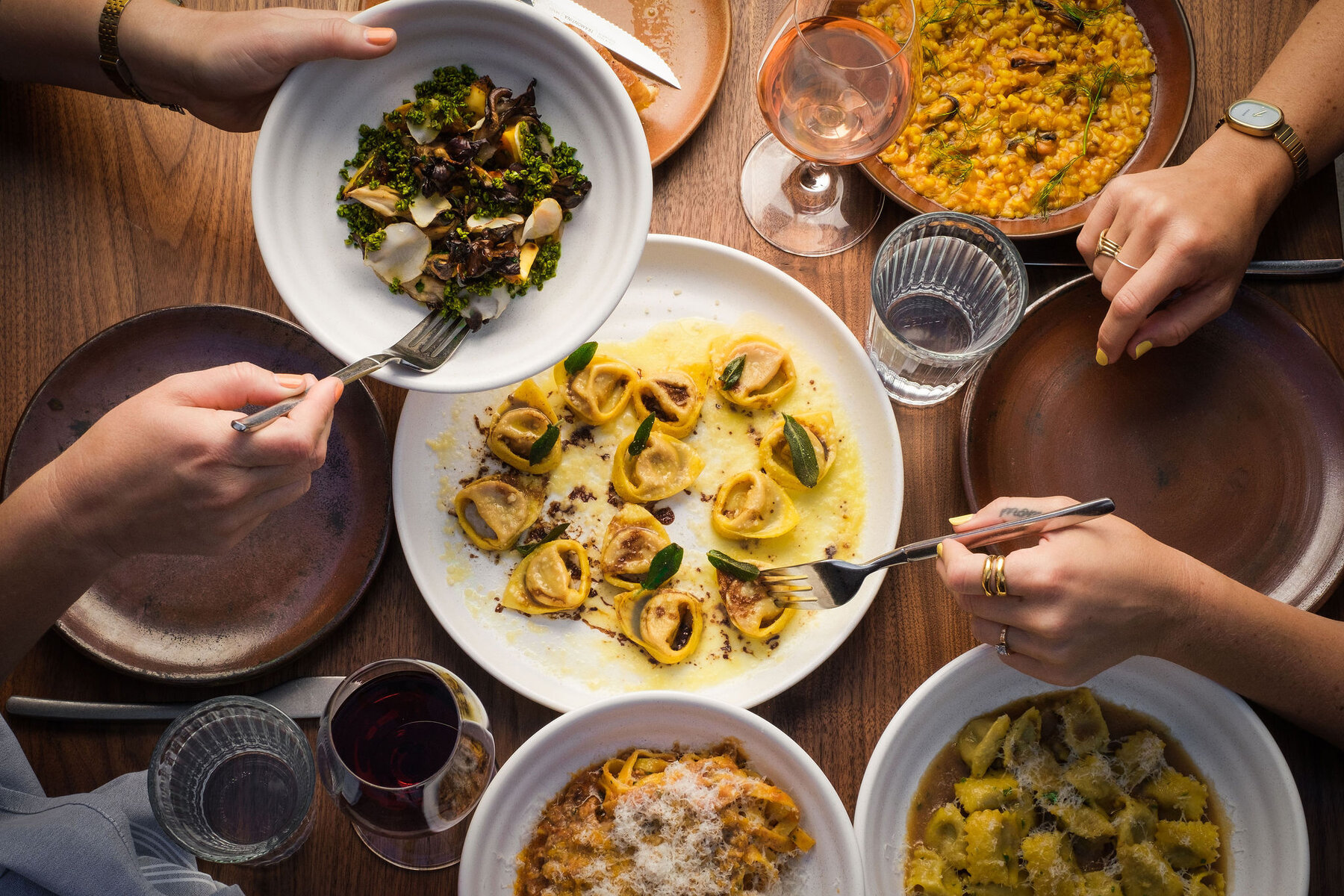 A spread of pasta dishes on a table at Penny Roma.