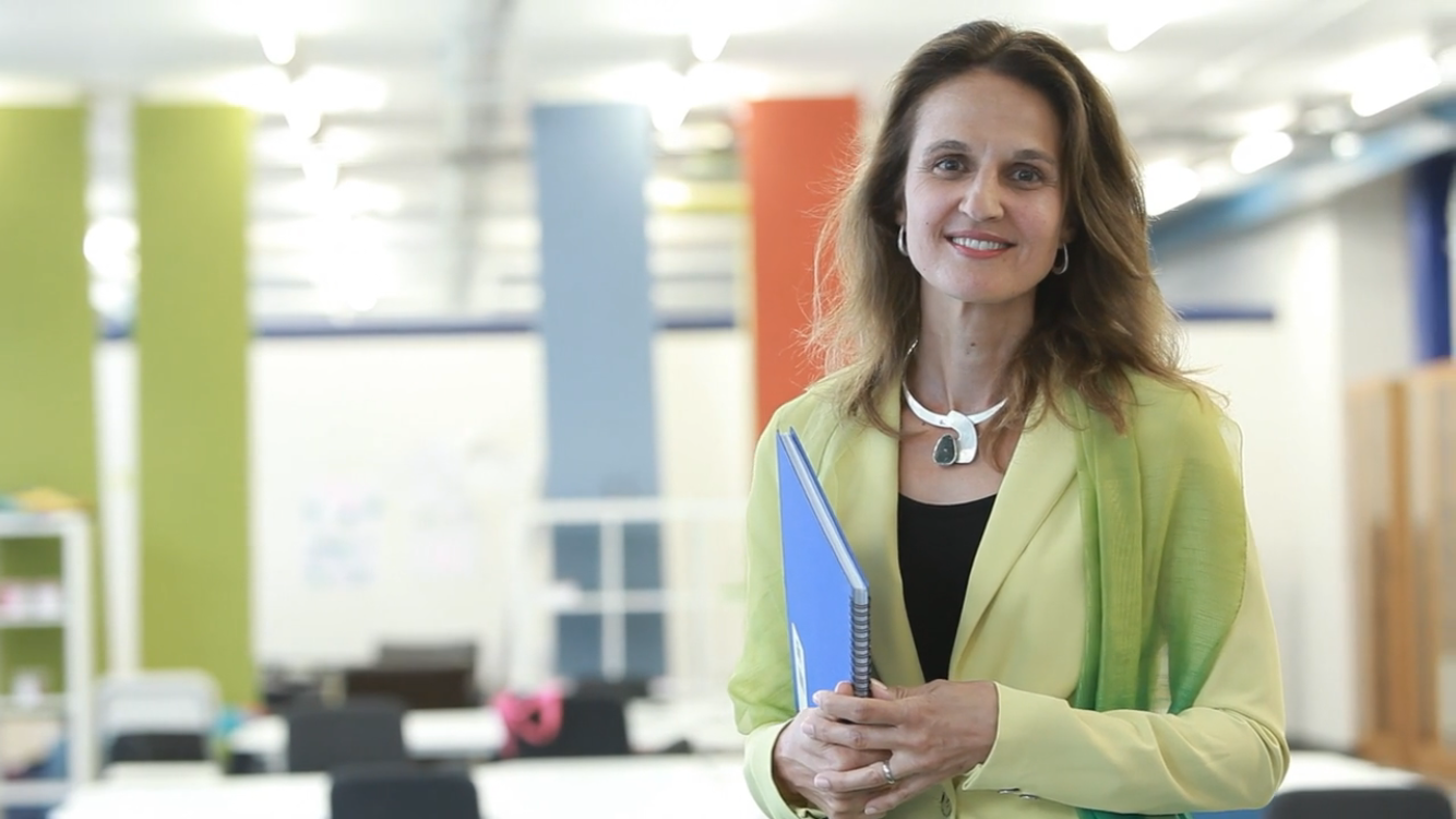 Irenka Krone poses in businesswear in an office.