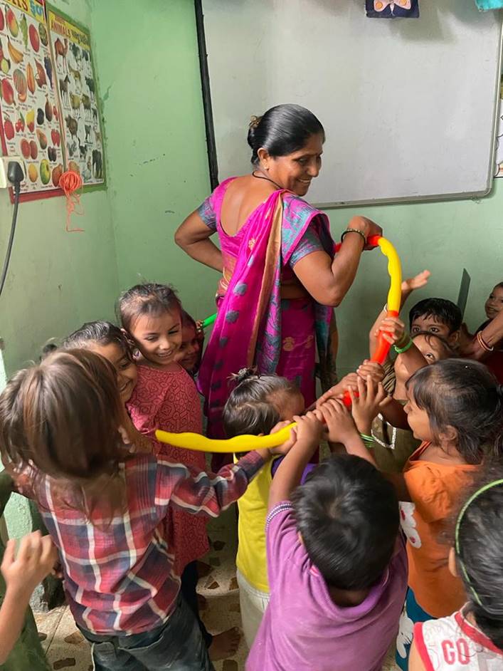 Young children play a game in a nursery.