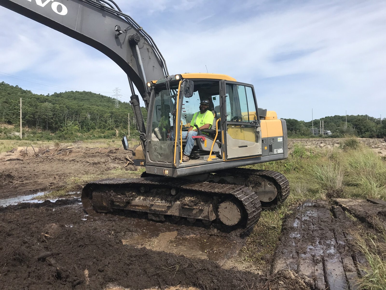 An earthmover doing construction work at a former cranberry bog.