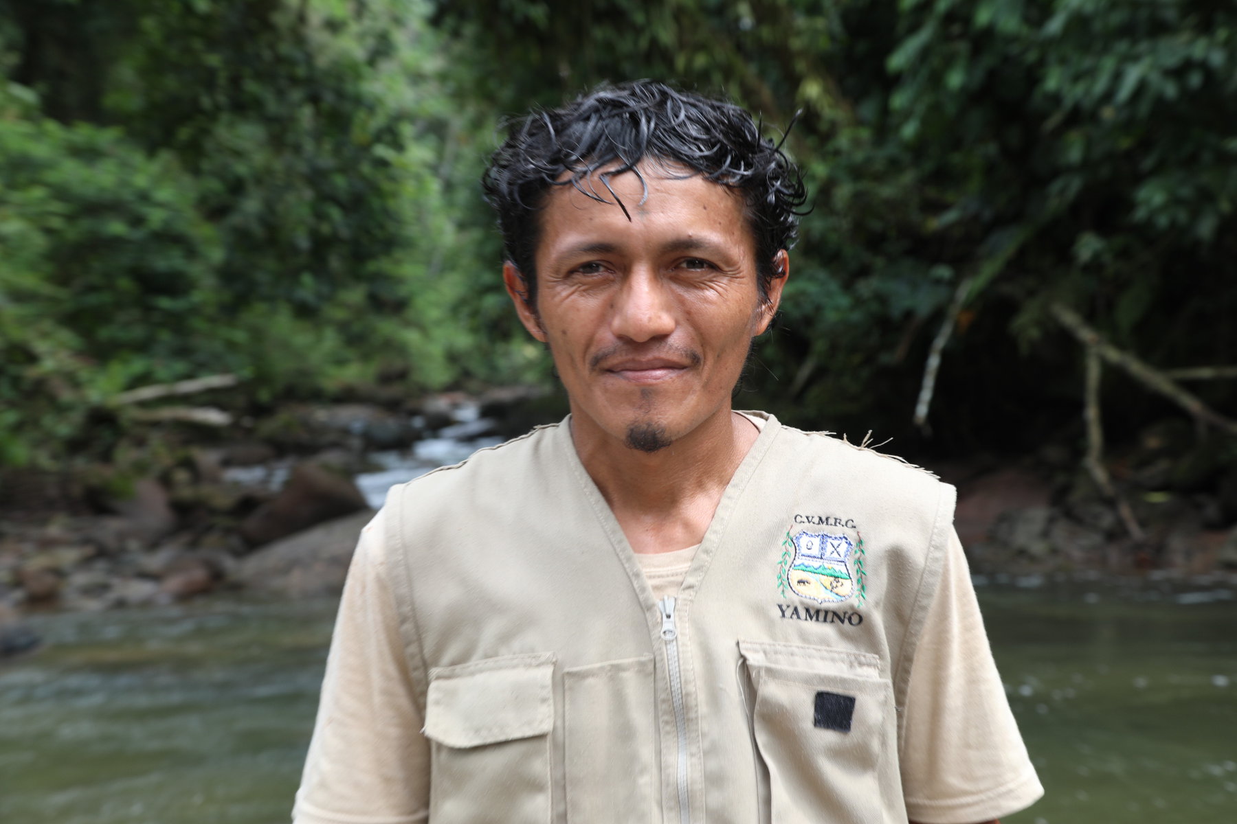Portrait of Cesar Lopez Tanchiva standing in the rainforest.