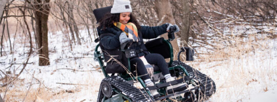 A woman using a track chair in the snow in Minnesota's Myre-Big Island State Park.