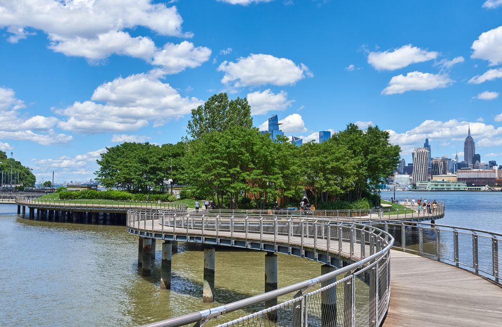 An elevated walkway over the water to an island park in Hoboken.