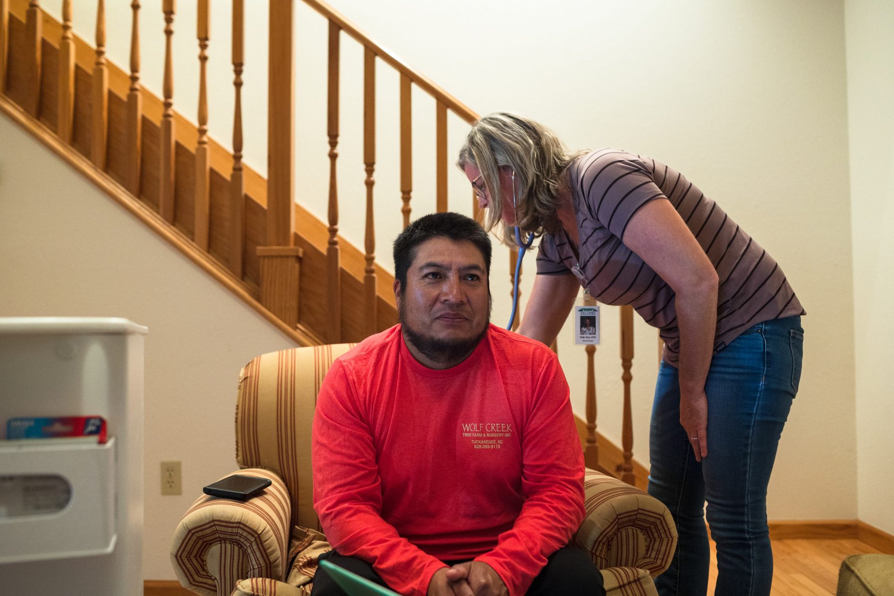 Family nurse practitioner Kelly Ware examines farmworker Andres Garcia during a farm visit by the Vecinos mobile medical clinic.