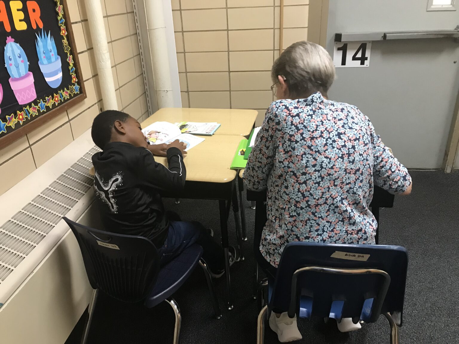Marge Mangelsdorf, a 22-year Oasis veteran, working with first grader Harlan. 
