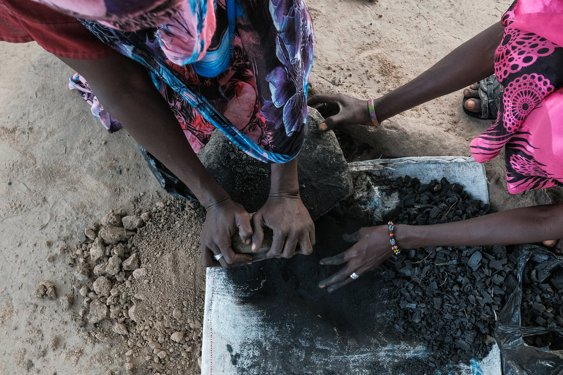 Women making charcoal briquettes.