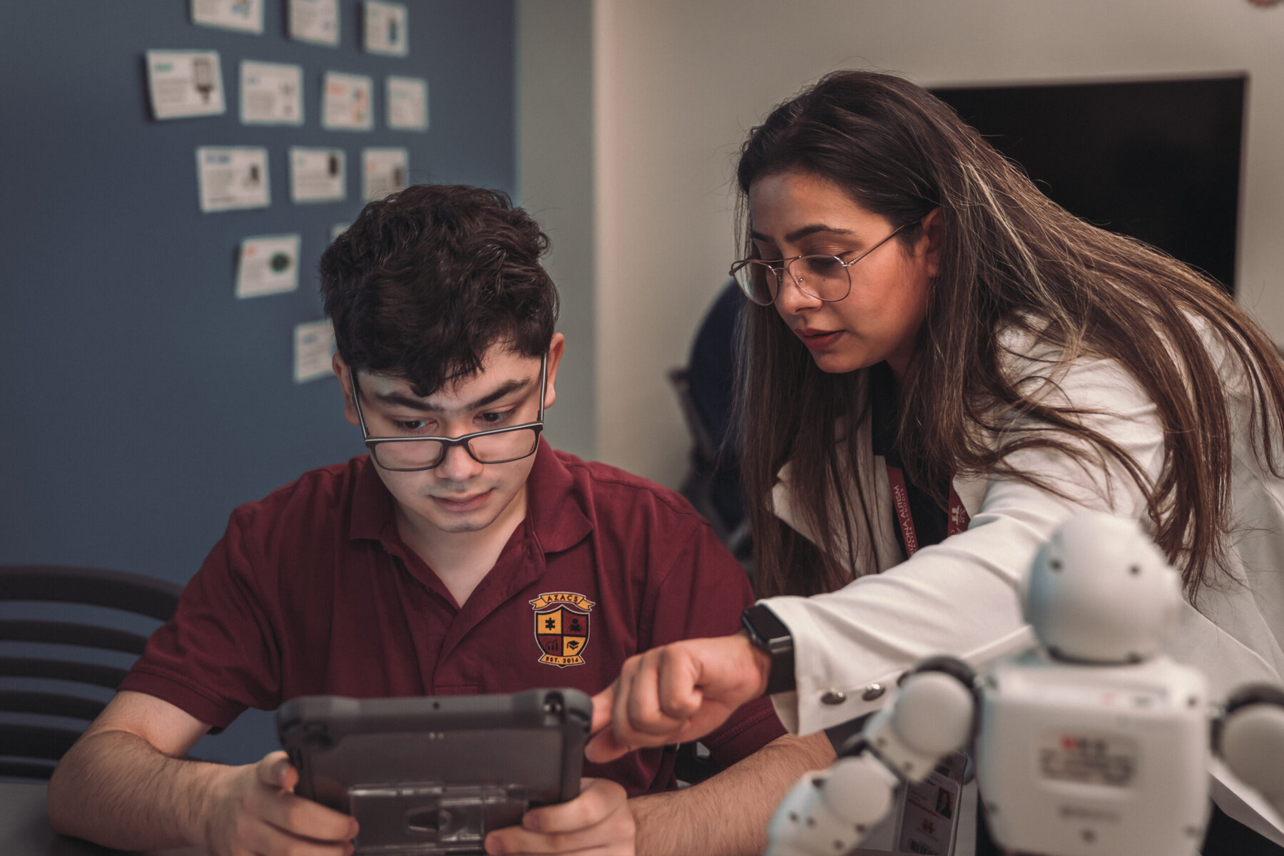 Supreet Kaur shows a high school student how to correctly use code to control the dancing robot as part of AZACS’ Woz ED curriculum.