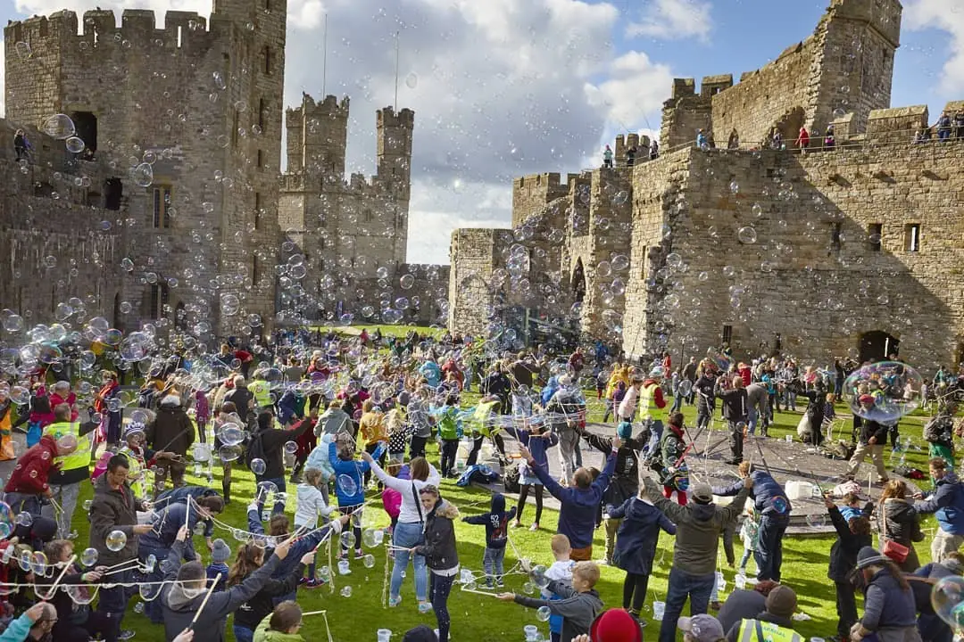 Children blowing bubbles at a castle.