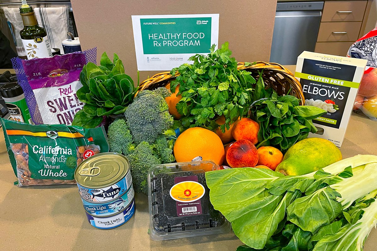 A meal kit distributed through the Healthy Food Rx program includes fruit, vegetables, and pantry staples such as nuts and canned tuna. 