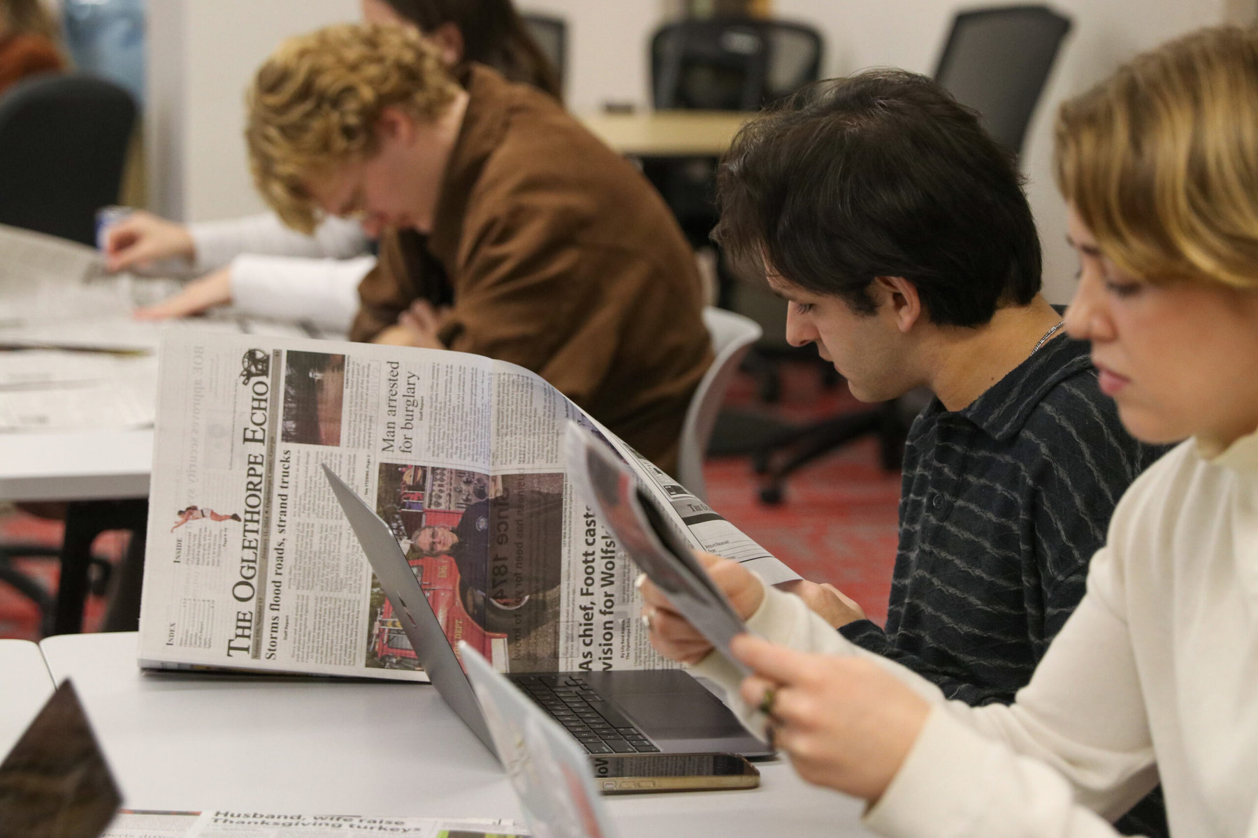 Current Echo students Michael Johnson (left) and Izzy Wagner read through a copy of The Oglethorpe Echo.