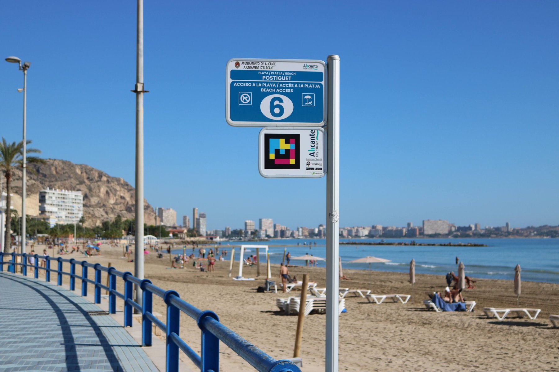NaviLens signage at a bus stop at Postiguet Beach in Spain.