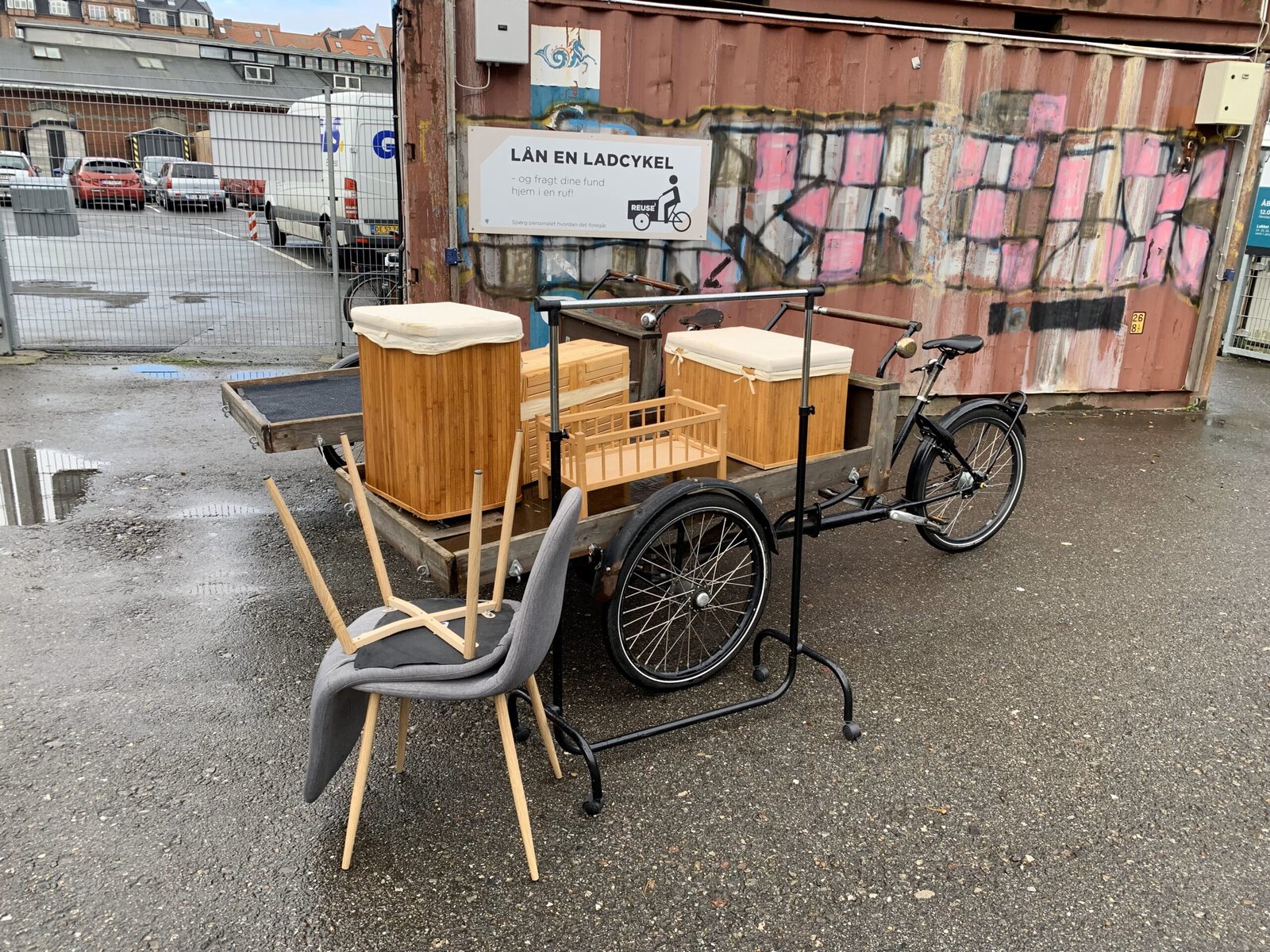 A cargo bike at a reuse center, carrying furniture.