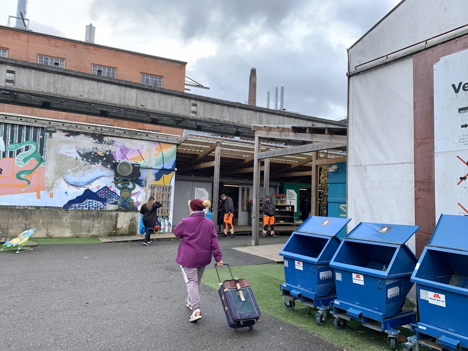 An elderly woman carries a suitcase at the circular economy center Reuse, in Aarhus, Denmark.