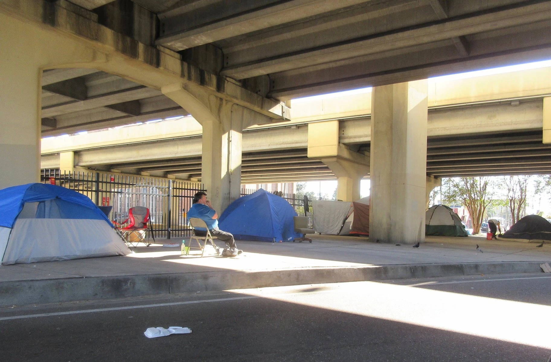 A homeless encampment in New Orleans beneath an expressway.