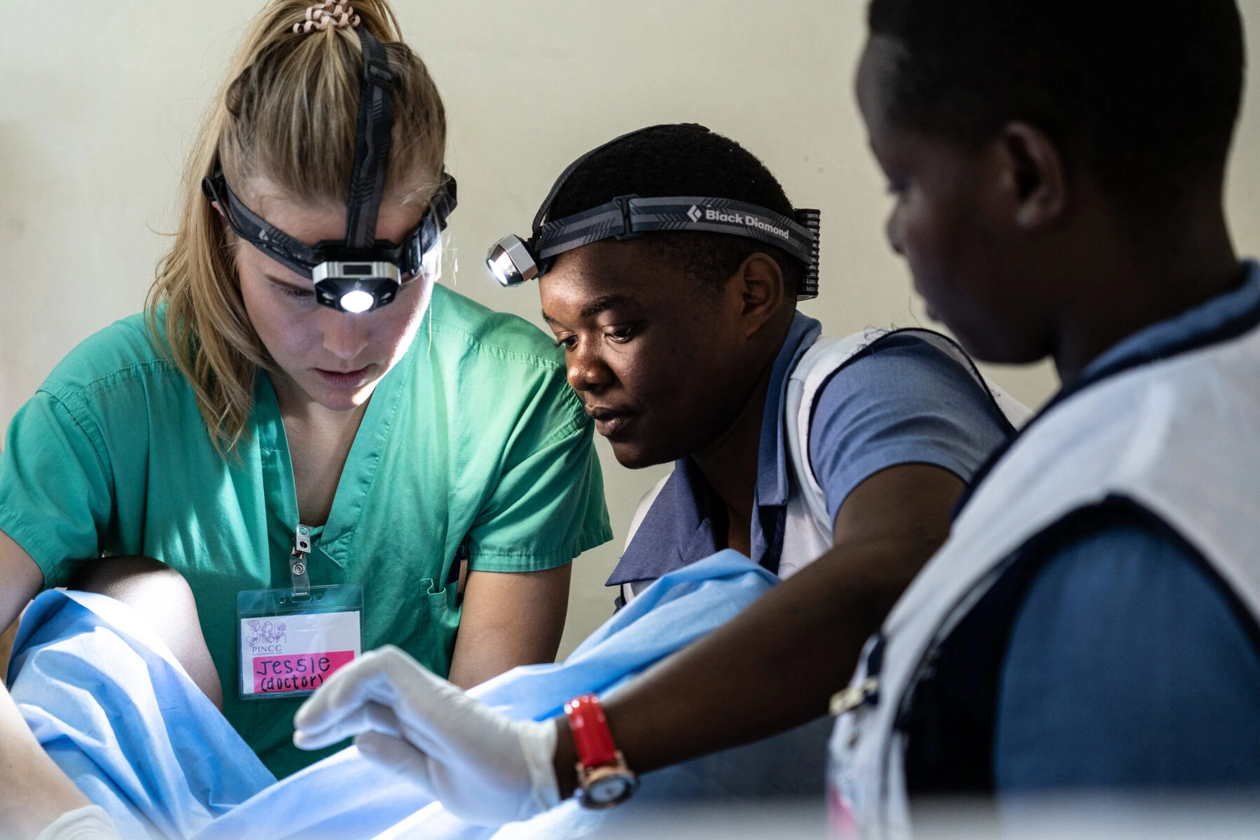 A doctor and volunteers perform an exam on a woman in Kenya.