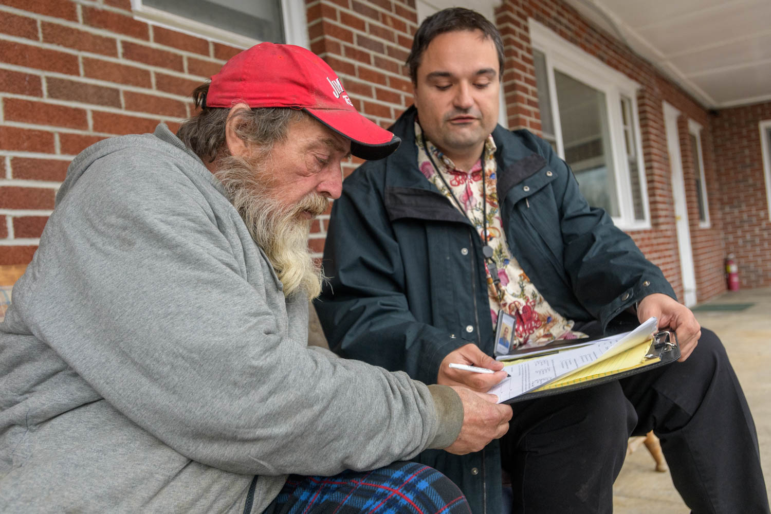 James Haley, left, a resident of the Ladd Brook Inn in Pownal, Vermont, reviews his housing options with Sam Urbon, a Turning Point Recovery Center staff member. 