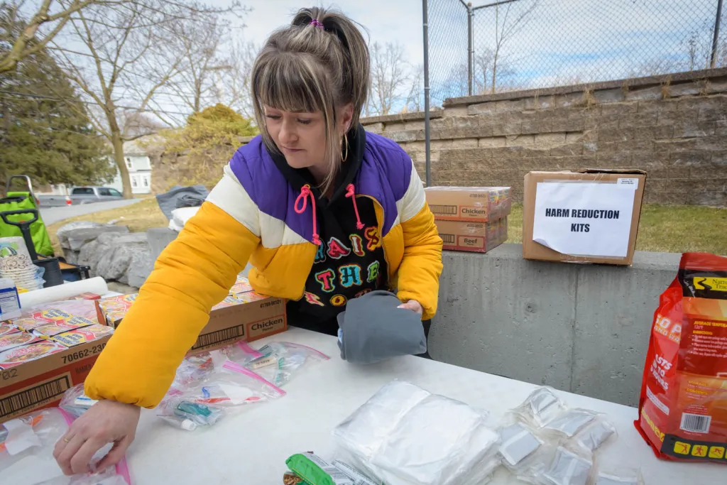 Turning Point Recovery Center staff member Jessica Daley prepares “harm reduction kits” and bags of toiletries for distribution at a Bennington, Vermont, food shelf.
