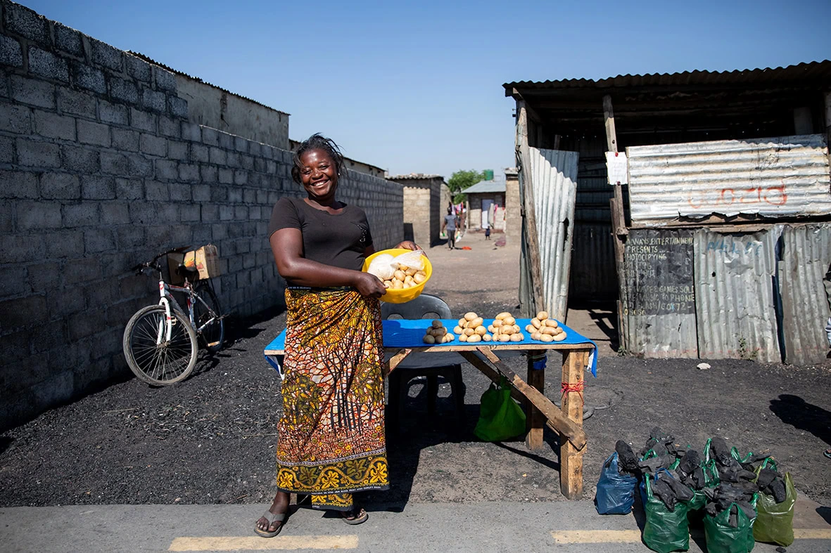 Esther, a member of a StrongMinds group, sells potatoes as a small business in Misisi Compound, Lusaka Zambia.