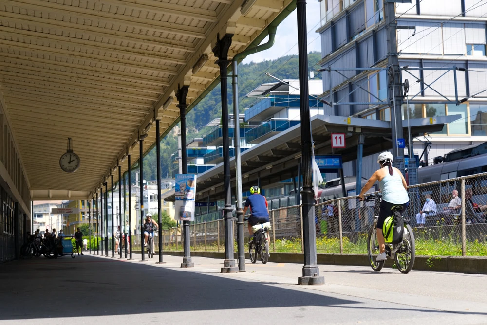 Cyclists pass the lake railway station in Bregenz.
