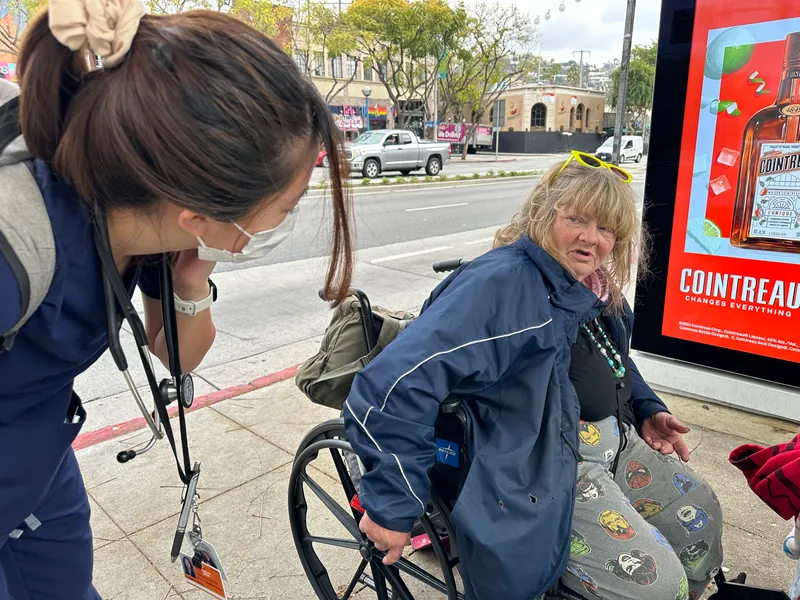 Isabelle Peng tries to talk with a homeless woman, Lisa Vernon, after receiving a call about someone in crisis on the streets.