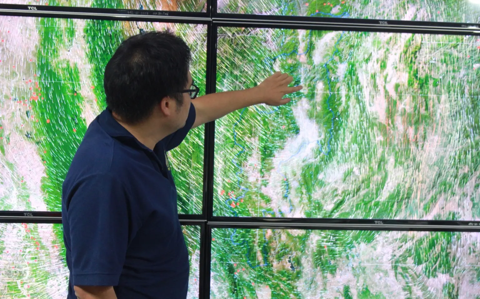 Nattapoom Nunto, a policy and planning Analyst in Chiang Mai, points to a screen in the War Room showing air movement across the region. 