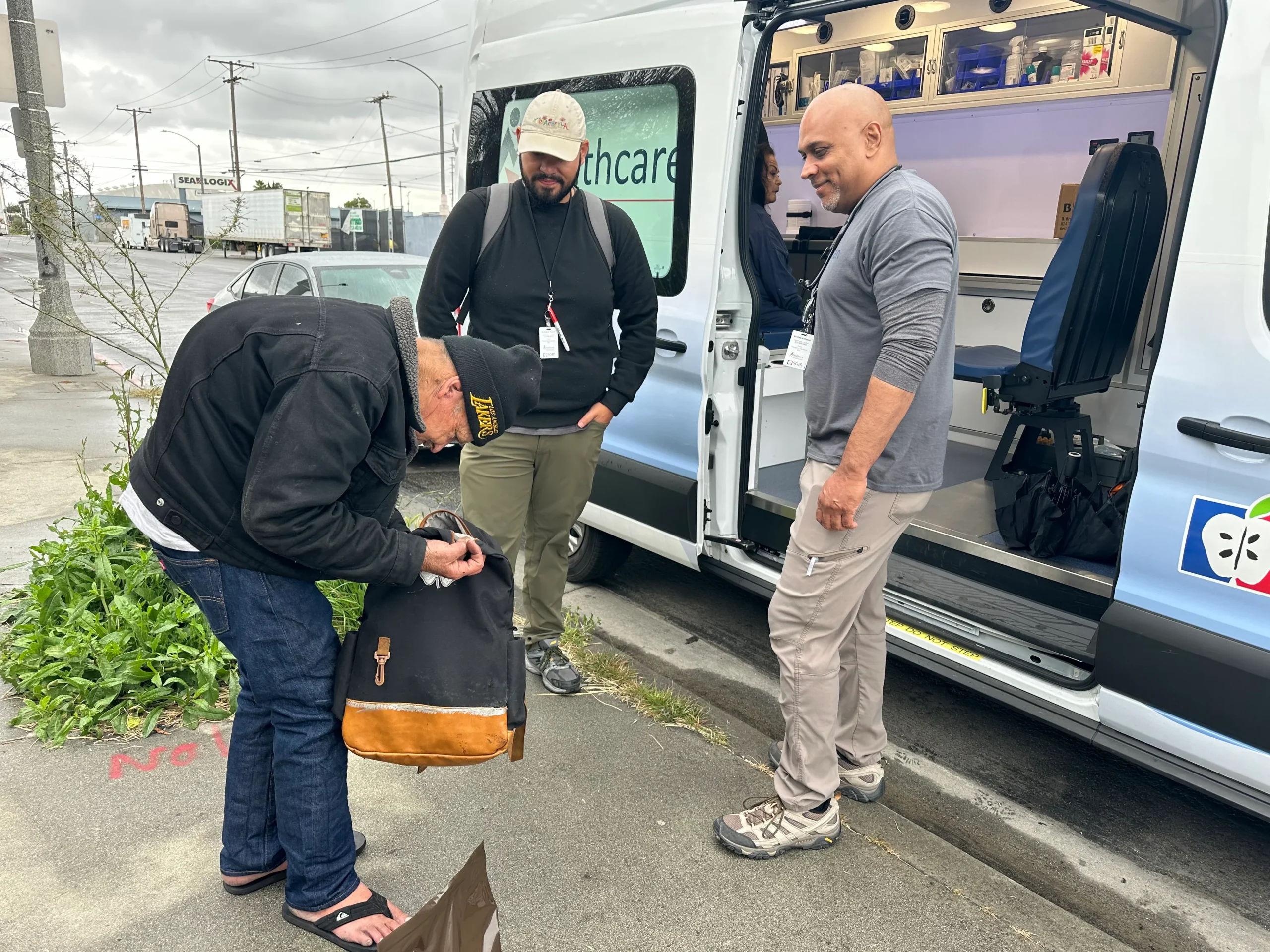 Daniel Speller, a street medicine provider for Healthcare in Action, welcomes patients in his mobilemedical van in Long Beach, California, on a cloudy April morning. 