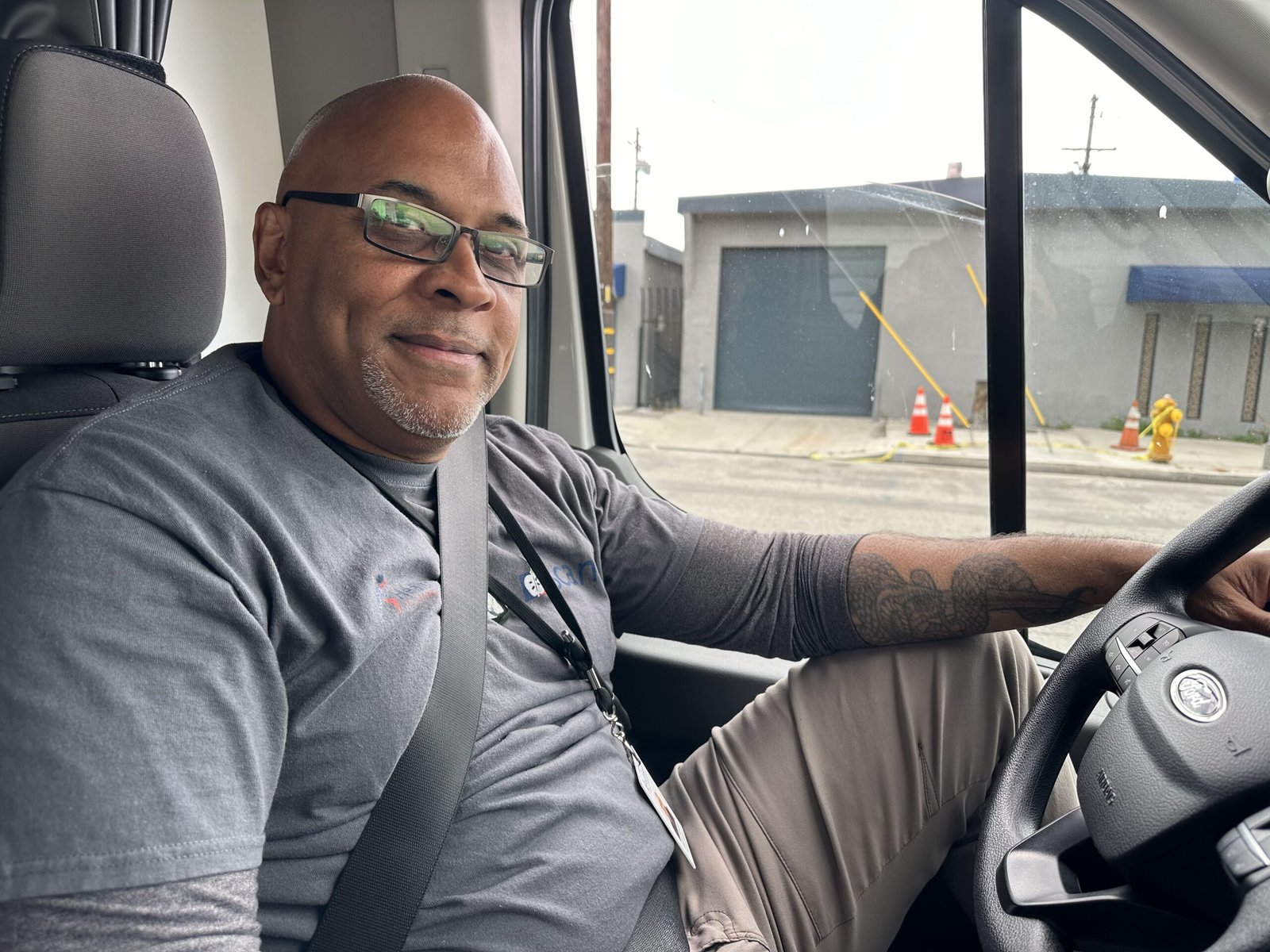 Physician assistant Daniel Speller, a street medicine provider, sits in a car.