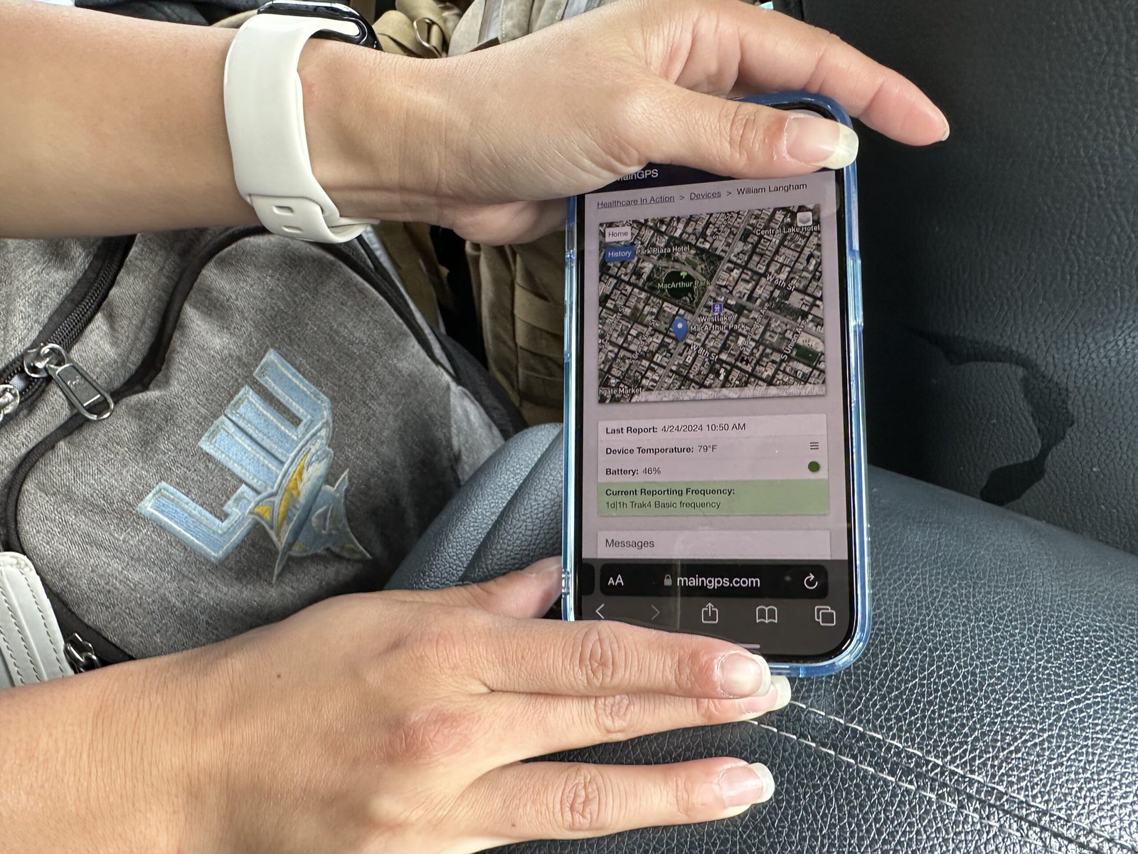 Isabelle Peng points on a phone to the location of a GPS tracking device attached to a homeless patient. 