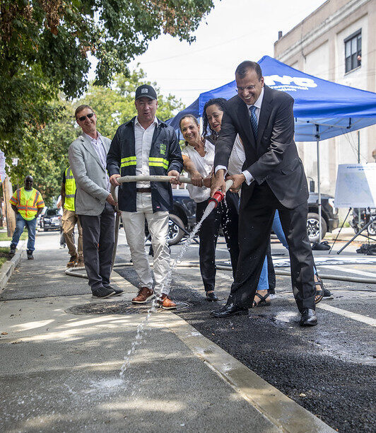 Rohit T. Aggarwala demonstrated the absorbing power of permeable pavement in Borough Park in July.