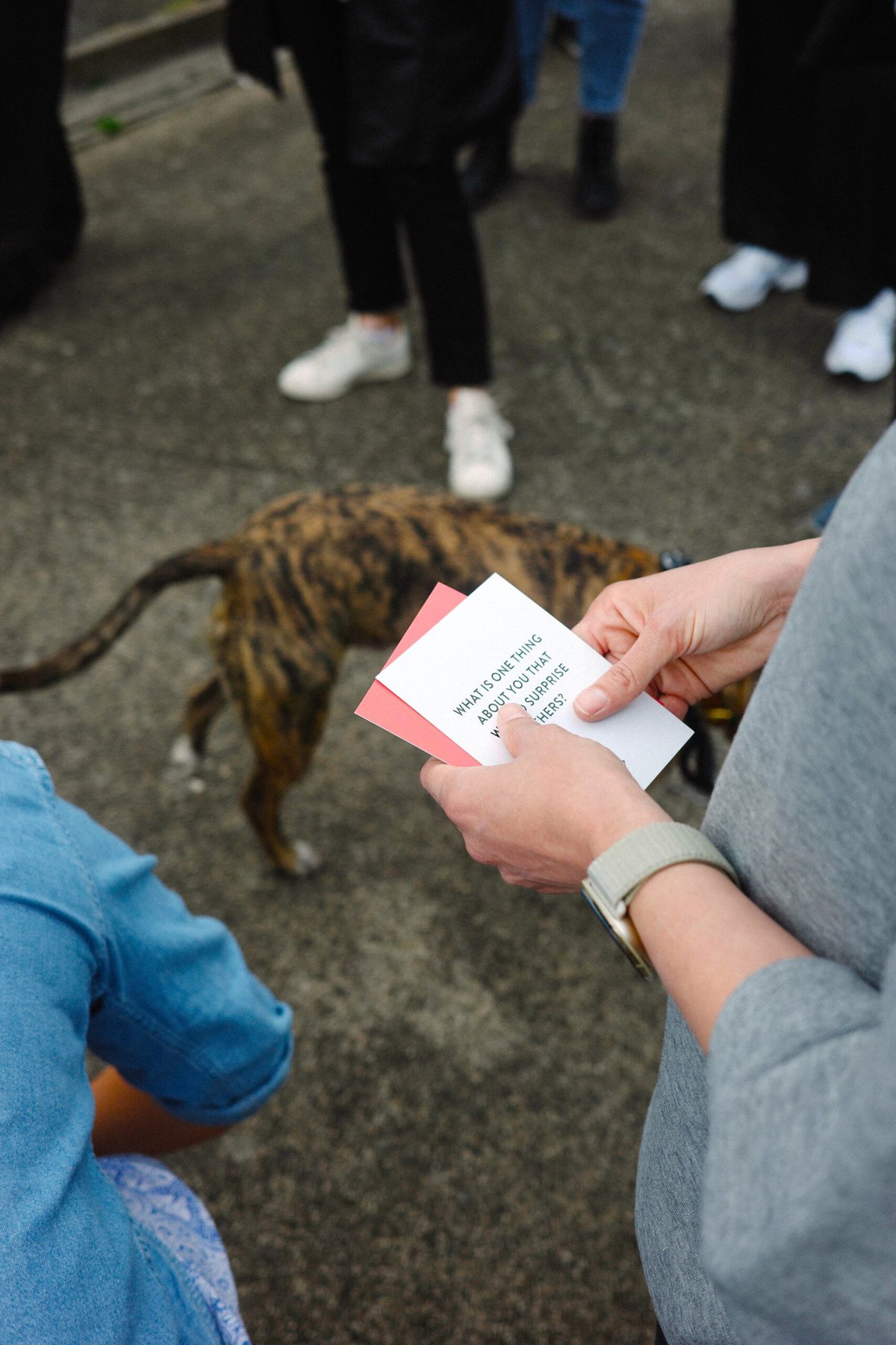 A walk participant holds a card with a dog in the background