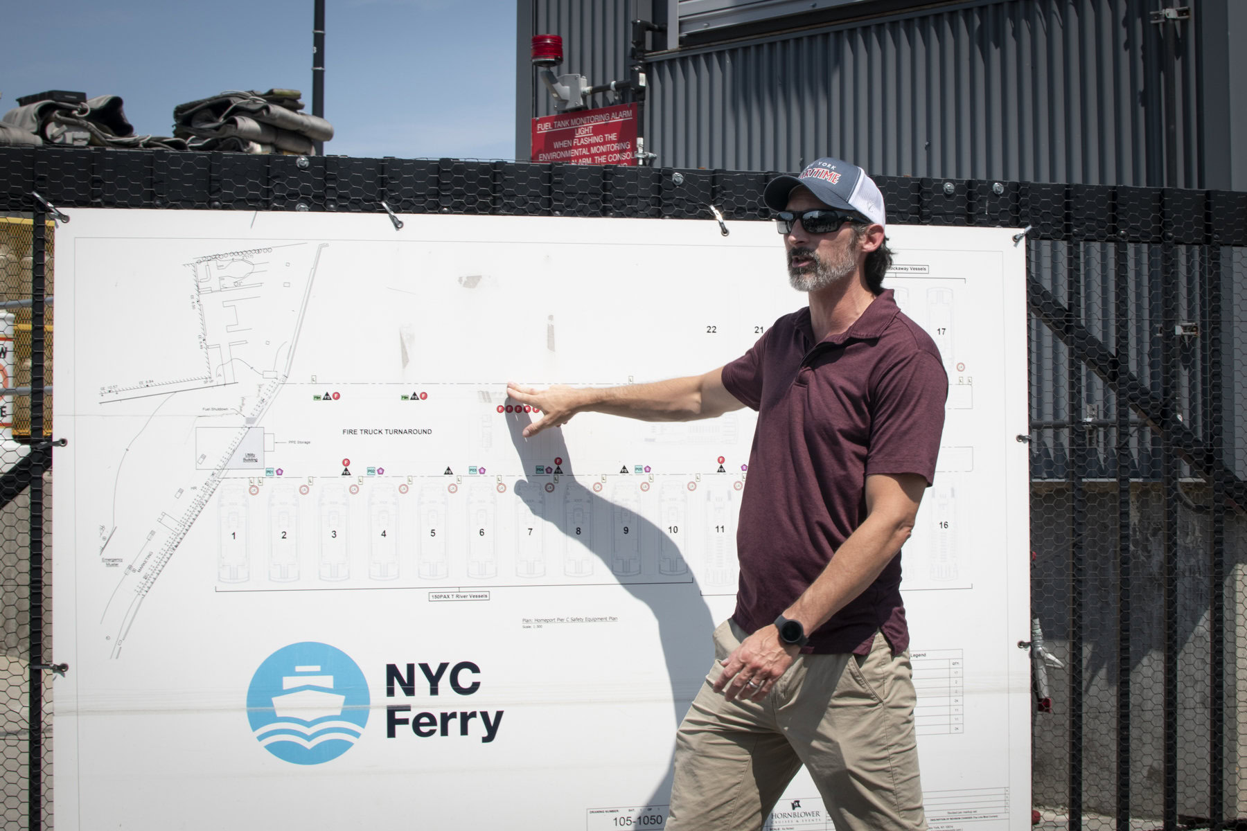 An NYC Ferry staff member brings the NYCHA Swim Corps participants on the tour of their docks at the Brooklyn Navy Yard.