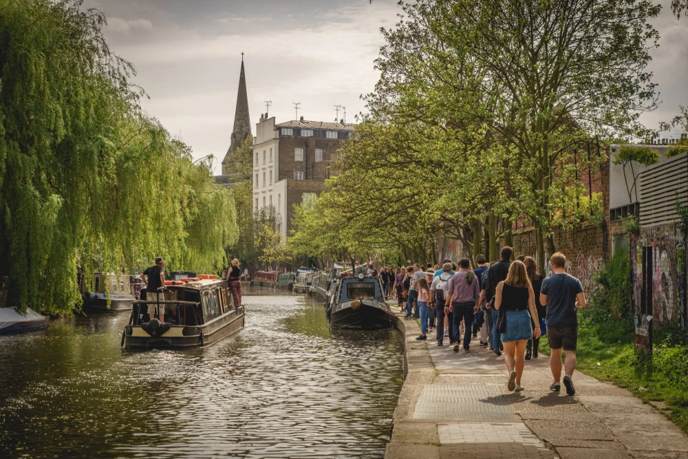 People walk along Regents Canal.