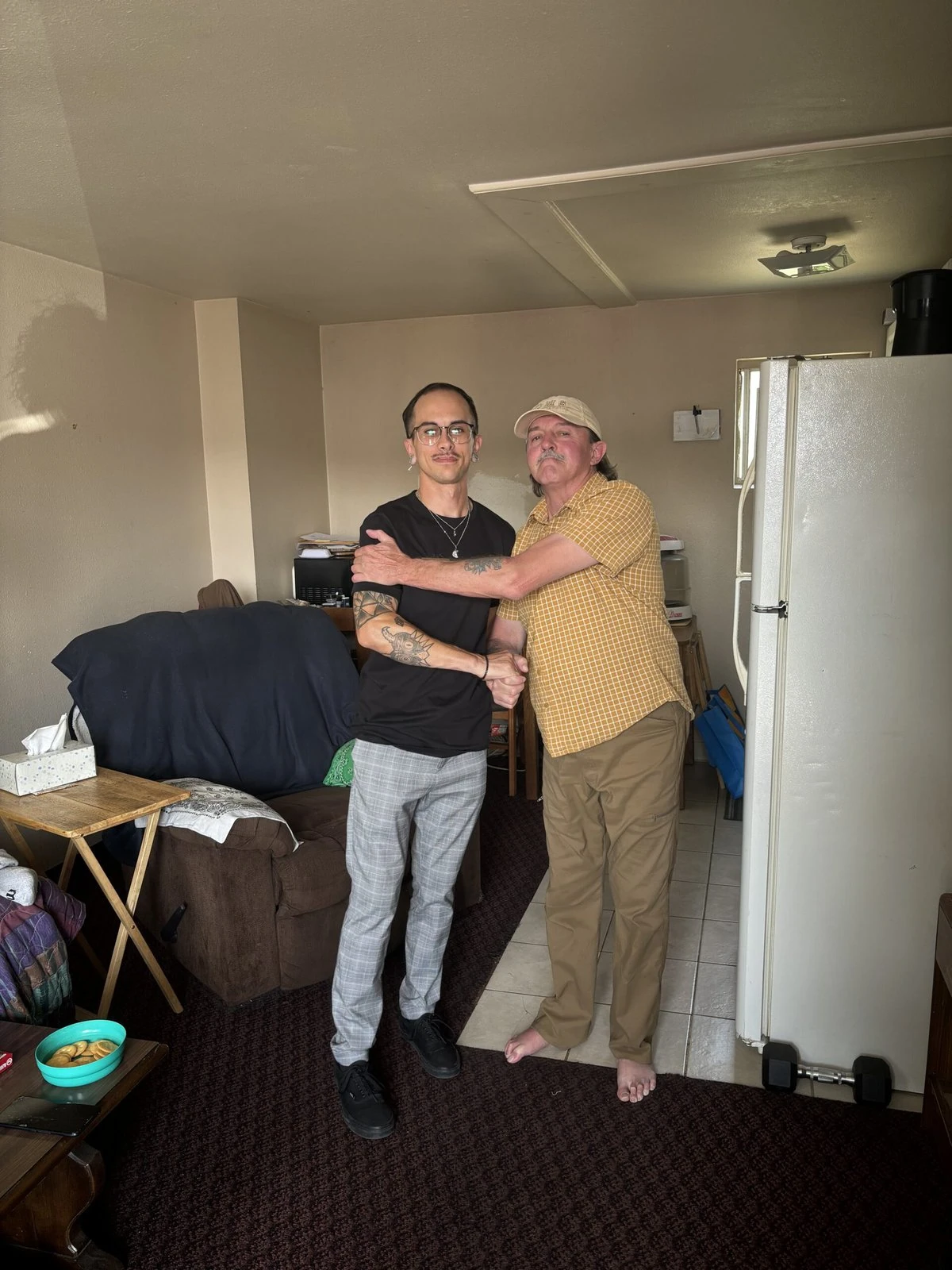 Two people hugging in a room at a medical respite.