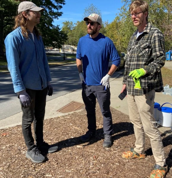 Nick Boyd, left and Will Heegaard, right, of the footprint project, along with volunteer Blake Davis, in Asheville.