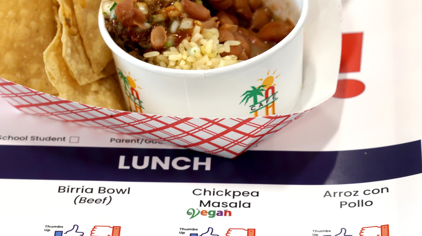 A vegan school lunch on top of a menu.