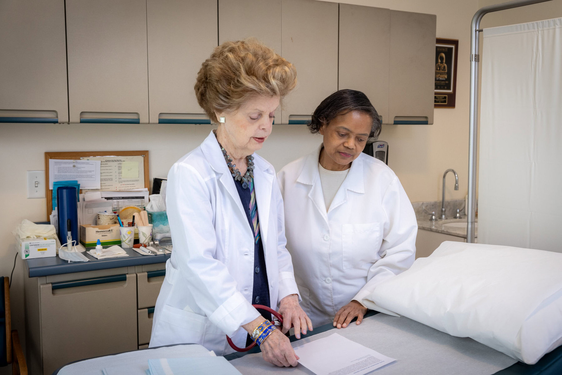 Marianne Legato goes over patient notes with a nurse.