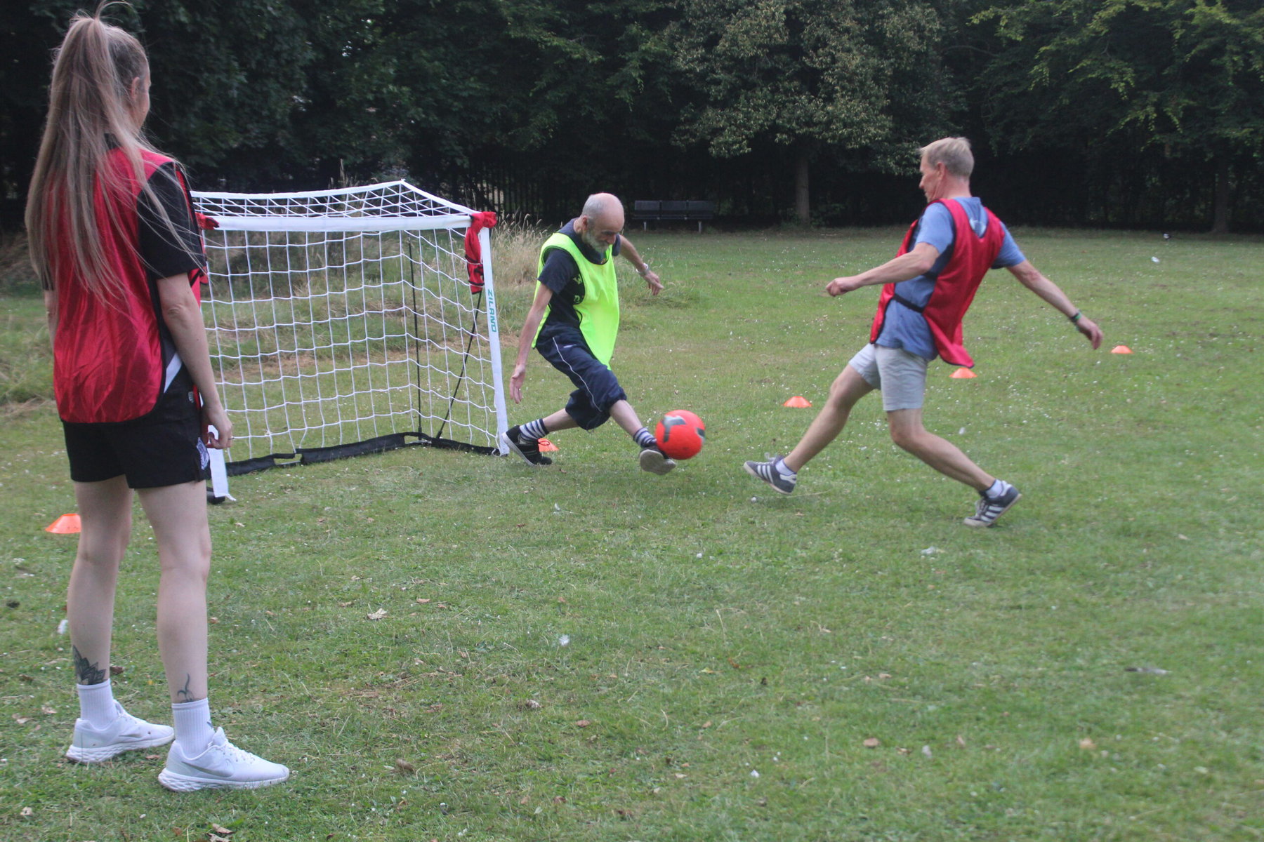 Two older men playing football.