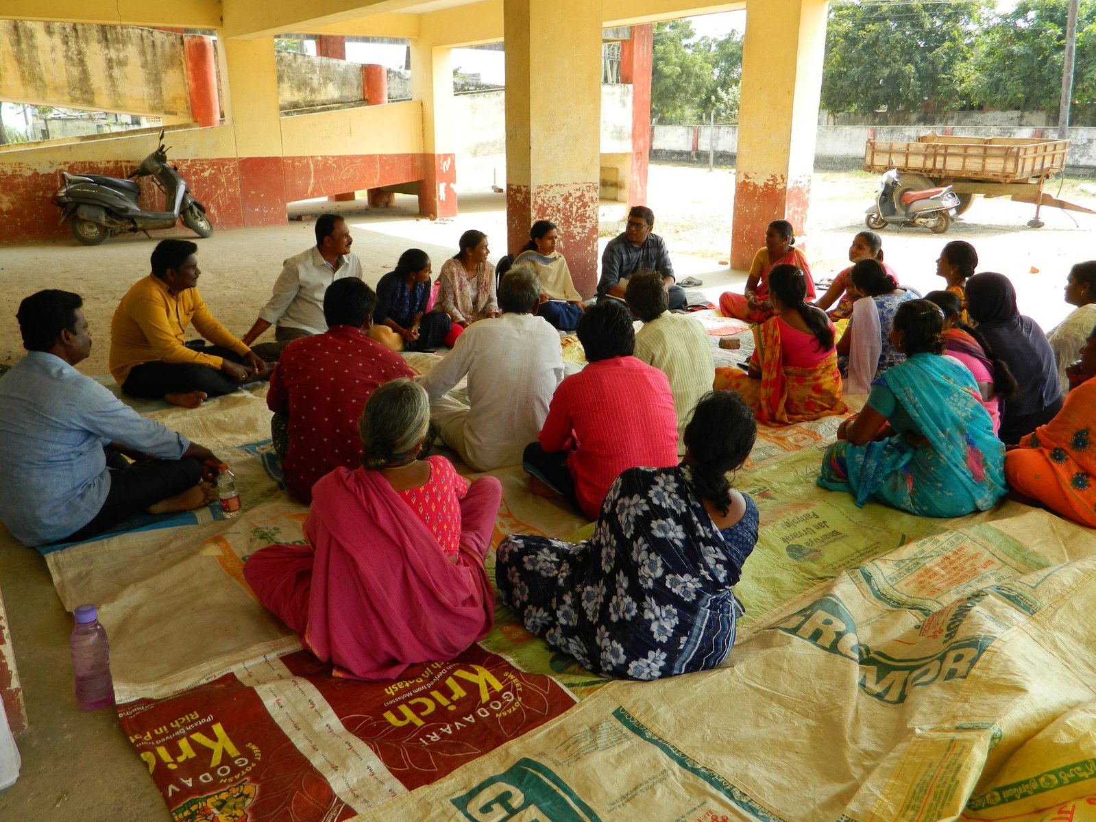 Villagers of Rangayapalem sit and listen to a lesson.