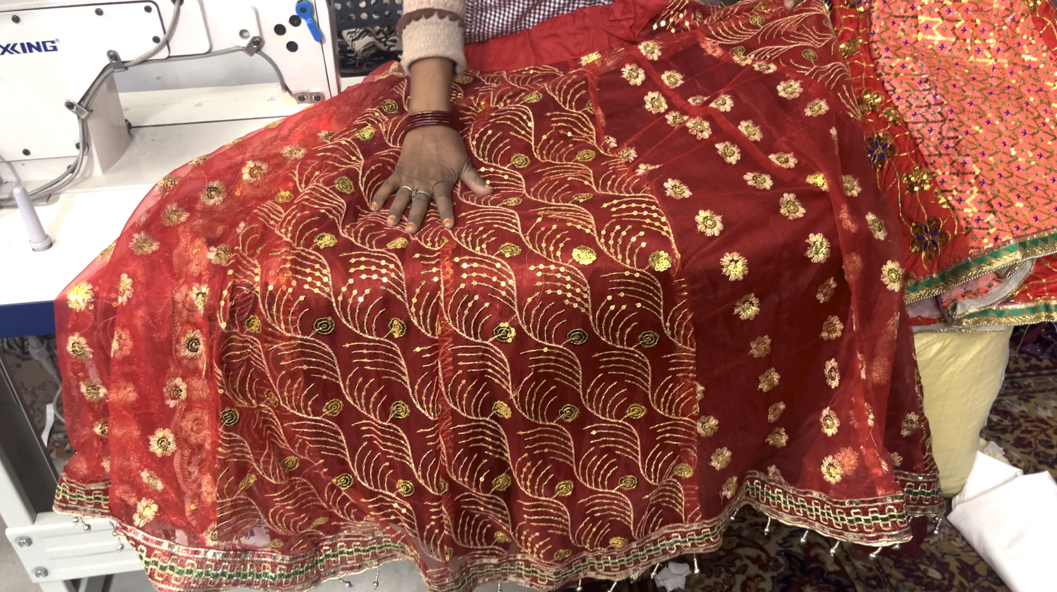 A woman displaying a wedding outfit.