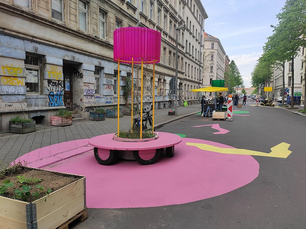 Leipzig's first superblock featuring bright pink street furniture.