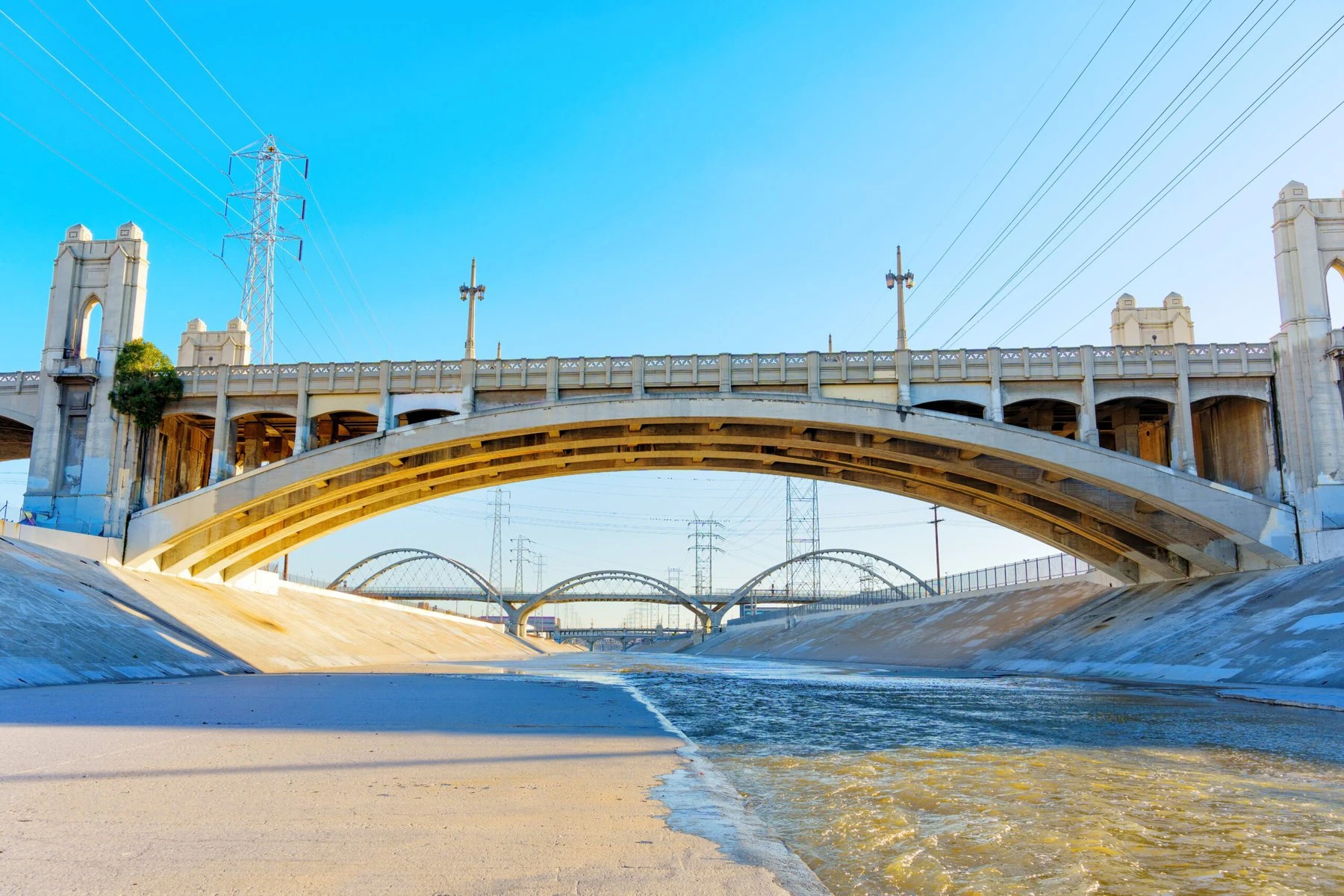 The LA River runs across concrete through an urban landscape.